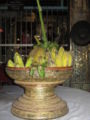 Traditional offerings of bananas and coconut at a Nat spirit shrine in Myanmar