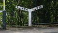Steam-age railway gradient post indicating a slope in both directions at Meols railway station, United Kingdom