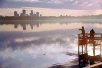Downtown skyline in view over Lake Calhoun and its dock