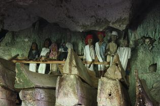 Toraja tau tau (wooden statue of the deceased) in South Sulawesi, Indonesia (also note the boat-shaped coffins)