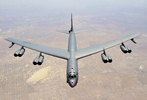 Aerial top/side view of gray B-52H flying over Texas