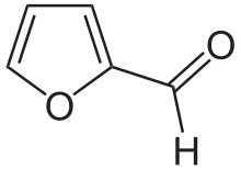 Skeleton formula of a ring of four carbons and one oxygen, with a carbon-oxygen attached to a carbon next to an oxygen