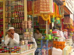 four men in traditional bridalwear shops in the market