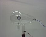 Crookes tube. The cathode (negative terminal) is on the right. The anode (positive terminal) is in the base of the tube at bottom.