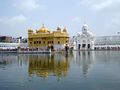 Harmandir Sahib (Golden Temple) with Clock Tower behind.