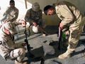 Kurdish Peshmerga contract guards cleaning their weapons, a variation of the AK-47 with folding butt-stock. These Peshmerga’s are employed as bodyguards and drivers for US Army Corps of Engineers (USACE) personnel at the USACE compound in Dahuk.