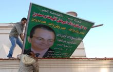 Egyptian demonstrators tear down a poster of President Hosni Mubarak in the Mediterranean coastal city of Alexandria on Wednesday, Jan. 25.