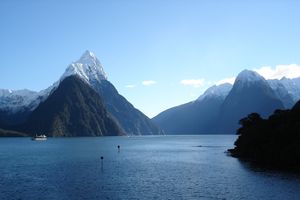 Blue water against a backdrop of snow capped mountatins