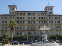 A view of one of Viareggio's many grand hotels along the famous passeggiata, with the "Fountain of the Four Seasons" by Beppe Domenici in front.