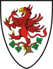Similarly, the coat of arms of Greifswald, Germany, in Mecklenburg-Vorpommern, also shows a red griffin rampant – perched in a tree, reflecting a legend about the town's founding in the 13th century.