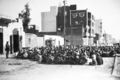 A soldier from the British 16th Parachute Brigade, left, keeps guard over Egyptians herded behind barbed wire in Ismalia, in the Suez Canal zone of Egypt, Jan. 22, 1952. Whilst these men were being screened, houses were being searched for arms and ammunition. Most of the men were later released. (AP Photo)