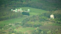 Aerial view of the Royal Greenwich Observatory, Herstmonceux site in East Sussex; the dome that formerly housed the Isaac Newton Telescope is the single dome to the right. The telescope was moved to La Palma in the Canary Isles in 1979.
