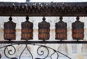 Rolling metal prayer wheels circling the Swayambhunath stupa, Kathmandu