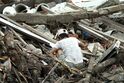 Man searching through rubble in Meulaboh after 2004 tsunami DM-SD-06-11957.JPEG