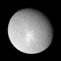 A spherical body is almost fully illuminated. Its grayish surface is covered by numerous circular craters. The terminator is located near the upper-right limb. A large crater can be seen near the limb in the upper-left part of the body. Another smaller bright crater can be seen in the center. It is surrounded by a large bright patch having the shape of a five-pointed star.