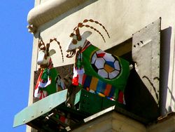 Goat-emblem of Poznań dressed in Euro 2012 flags (left) and the Euro 2012 logo made of flowers in Lviv (right).
