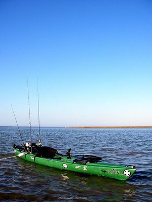 Photo of large two-person kayak with multiple fishing poles attached at stern
