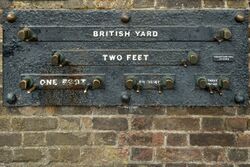Imperial standard lengths on the wall of the Royal Observatory, Greenwich, London – 1 yard (3 feet), 2 feet, 1 foot, 6 inches (1/2-foot), and 3 inches. The separation of the inside faces of the marks is exact at an ambient temperature of 60 °F (16 °C) and a rod of the correct measure, resting on the pins, will fit snugly between them.[71][72]