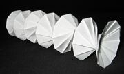Mathematical origami: Spring Into Action, by Jeff Beynon, made from a single paper rectangle.[196]