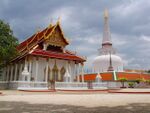 A Buddhist temple with a large white stupa