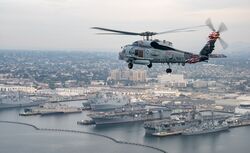 An MH-60R Sea Hawk helicopter flies over Naval Base San Diego during 2017