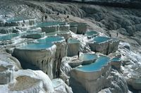 The limestone layers in the pools rise up in steps, one above the other, and the continual flow of water keeps this process in operation. The stalactites form one of the most important features in the landscape.