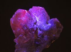Rough alexandrite under UV light