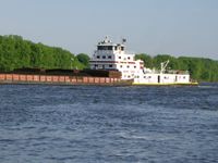 Tugboat Bill Berry of the Ingram Barge Company pushing cargo barges up the Mississippi River at Dubuque, Iowa