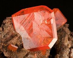 An irregular piece of native copper on a green background.