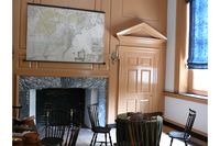 A room with chairs and small tables