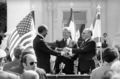 President Jimmy Carter stands center stage flanked by Egyptian President Anwar Sadat, left, and Israeli Prime Minister Menachem Begin as the three leaders shake hands following the signing of the Middle East peace treaty at the White House in Washington, March 27, 1979. The ceremony took place outside the Executive Mansion on the North Lawn. (AP Photo)