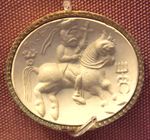 Kushan Carnelian seal representing the "ΑΔϷΟ" (adsho Atar), with triratana symbol left, and Kanishka the Great's dynastic mark right