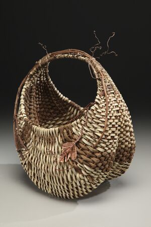 A basket with a large vine and its tendrils incorporated into the weave