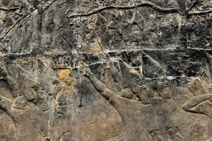 Wall relief showing men hurling stones towards an enemy