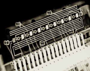 Eight small rectangular blobs, which are the digits, connected by fine hair-like wires to tracks along a circuit board