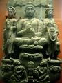 Buddha triad and kneeling Kushan devotee couple. 3rd century.