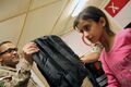 U.S. Army Capt. Syed Ali, left, with the regional communications center with Combined Joint Task Force (CJTF) 101, 101st Airborne Division, issues school items to Afghan children at the El Salam Egyptian Field 130827-A-YW808-007.jpg