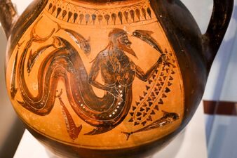 Triton, with a fishtail, holding a dolphin